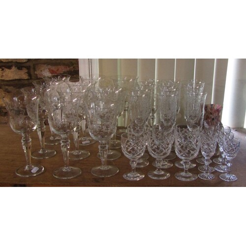 A suite of drinking glasses with etched leaf and flower deta...