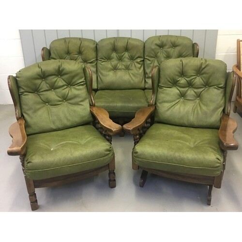 A vintage Oak-framed, green, faux leather suite. Three seate...