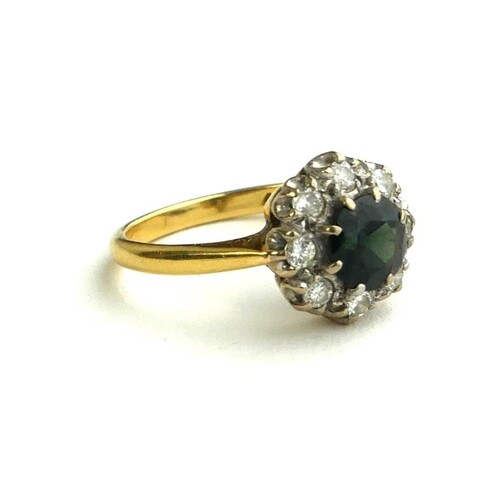 AN 18CT GOLD AND PLATINUM RING, SET WITH A CENTRAL SAPPHIRE ...