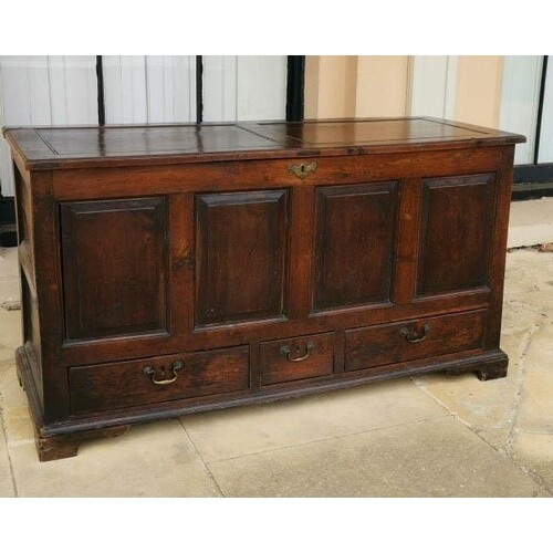 AN 18TH CENTURY OAK MULE CHEST Having a panelled top and fro...