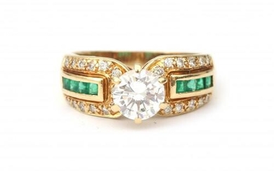 An 18 karat gold emerald and diamond solitaire ring, 1.07 ct. Featuring a brilliant cut diamond of 1.07 ct., G colour, VS2 clarity. The shank is set with carré cut emeralds and twenty six single cut diamonds, ca. 0.30 ct. in total. Incl. IGI diamond...