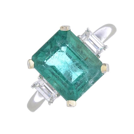 An 18ct gold emerald and diamond ring. The