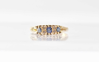 An 18ct yellow gold ring set with three sapphires and...