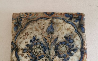 An 18th-19th century Persian tile, decorated in blue with leafs and flowers. H. 2. 13.5×13.5 cm.