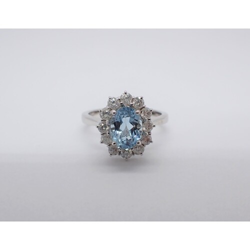An Aquamarine and Diamond Cluster Ring claw-set oval-cut aqu...