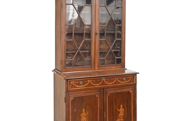 An Edwardian mahogany, satinwood and inlaid bookcase, the pa...