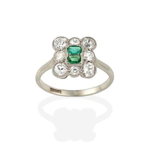An Emerald and Diamond Cluster Ring, two emerald-cut emeralds...