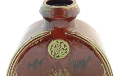An Oriental sang de boeuf vase of shaped form with