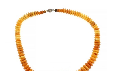 An amber necklace set with numerous milky amber roundels. Silver coloured magnet clasp. L. 61 cm.
