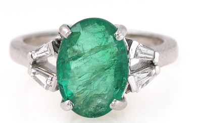 An emerald ring set with an oval-cut emerald weighing app. 1.85 ct....