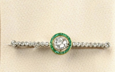An old-cut diamond and emerald brooch.Principal diamond