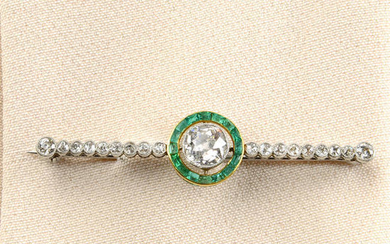 An old-cut diamond and emerald brooch.