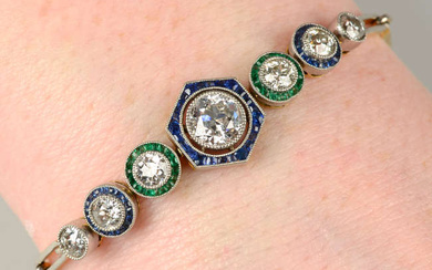 An old-cut diamond bracelet, with calibre-cut sapphire and emerald surrounds.