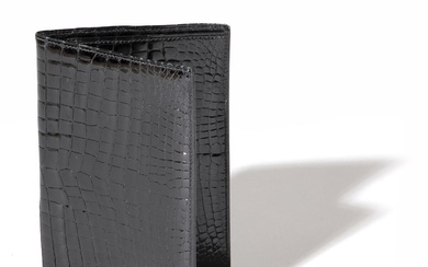 Hermès A wallet of black crocodile skin with five interior pockets. H....