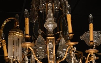 STATEMENT // Important chandelier with bronze pendants and nine light arms. Louis XV style, early 20th century (one branch to be resoldered; mounted for electricity, Accident to the glass that encompasses the central shaft). Diam : 60, H : 128 cm...