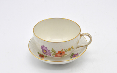 KPM CUP WITH SAUCER, FLOWER MOTIF AND BASKET WEAVE STRUCTURE, GOLD RIM, 19TH CENTURY.