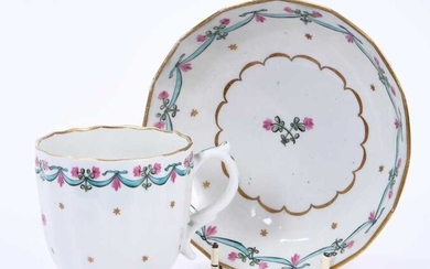 Lowestoft coffee cup and saucer, of faceted form with a scrolled handle, the centre in pink and green with with a flower sprig within a gilded band, a 'Bungay' border enclosing a band of gilt stars...