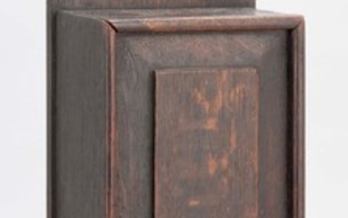 OAK CANDLE BOX With dovetailed sides, sliding panel front and an old brown finish. Height 19.5". Width 6". Depth 3.25".