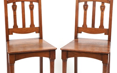 Pair of Arts & Crafts oak side chairs carved with hearts, 96...