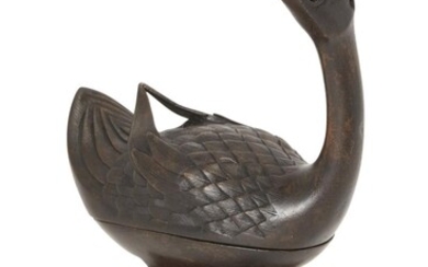 Property of a Gentleman (Lots 55-80) A Chinese bronze duck incense burner, Ming dynasty, 17th century, cast standing on one leg with head raised, the cover detailed with feathers, 25cm high, later wood stand 明 十七世紀 銅 鴨形熏爐 來源：紳士私人收藏