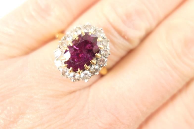 Ruby and diamond cluster ring, the oval cut ruby...