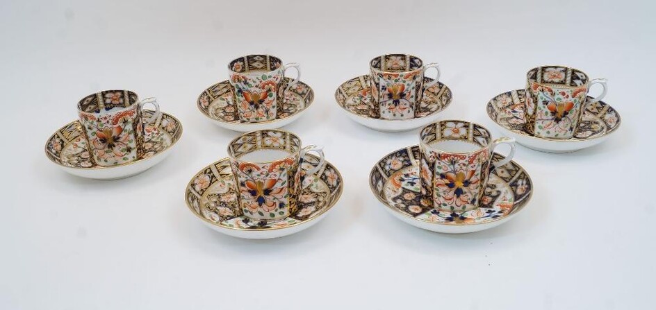 Six Derby Imari coffee cans and saucers, 19th century, with floral and foliate decoration with gilt detailing, having red crossed batons marks to undersides (12)