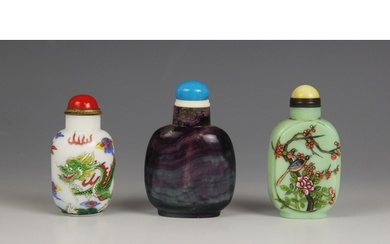 Three Chinese snuff bottles and stoppers, comprising; an ame...
