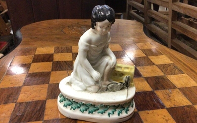 Unusual Victorian Staffordshire figure of a girl with two rats or mice, the oval base decorated with a foliate pattern