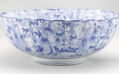 BLUE AND WHITE PORCELAIN BOWL In flower form with transfer design of sages in a bamboo grove. Diameter 15.6".
