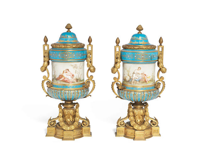 A pair of late 19th century French gilt bronze and Serves style 'bleu celeste' porcelain garniture urns and covers