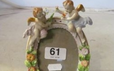 A small Sitzendorf style mirror with angle surmount and applied flowers.