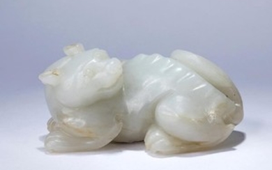 A WHITE JADE CARVING OF A MYTHICAL BEAST