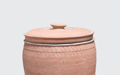 An unglazed stoneware storage jar and lid