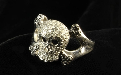 A 10 Carat White Gold Skull Ring studded with Diamonds on a millegrain setting. The shank stamped I