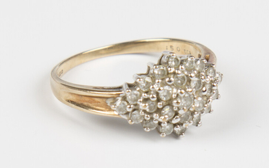 A 9ct gold and diamond marquise shaped cluster ring, claw set with circular cut diamonds, detailed &
