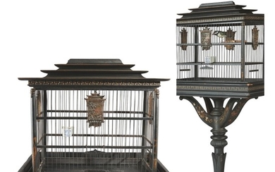 A CARVED AND EBONIZED WOOD BIRD CAGE ON STAND IN THE CHINESE TASTE