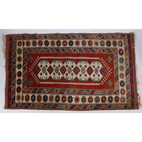 A Caucasian Rug, having a red ground set with central star g...