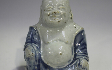 A Chinese blue and white glazed biscuit porcelain figure of Buddha, Kangxi period, modelled seated w