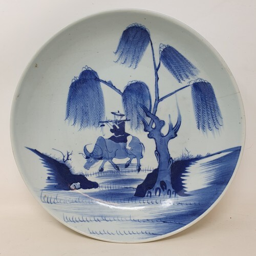 A Chinese shallow dish, decorated a man playing a flute ridi...
