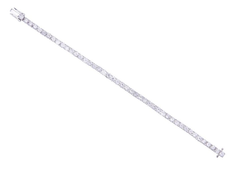 A DIAMOND LINE BRACELET - Comprising forty five round brilliant cut diamonds totalling 8.24cts, in 18ct white gold, total length 165mm.