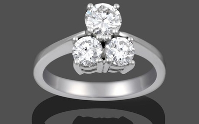 A Diamond Three Stone Ring, the graduated round brilliant cut...