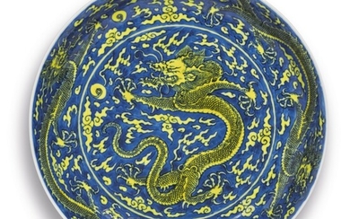 A FINE YELLOW-ENAMELED AND BLUE-GROUND 'DRAGON' DISH, KANGXI MARK AND PERIOD
