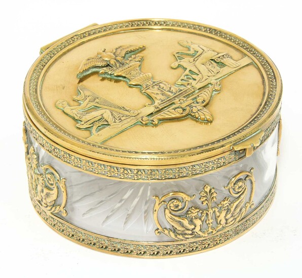 A French Empire gilt metal mounted circular glass table box