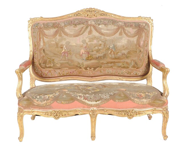 A French carved giltwood and upholstered settee in the Louis XV style
