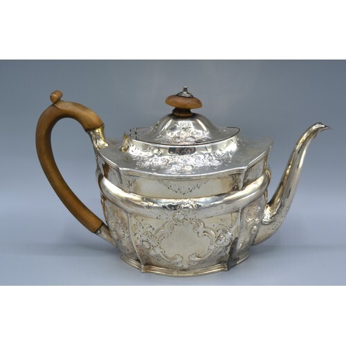 A George III Silver Teapot of foliate and scroll embossed fo...