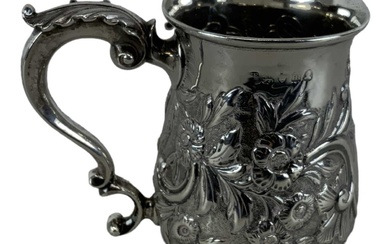 A George III hallmarked silver mug with floral decoration, London...