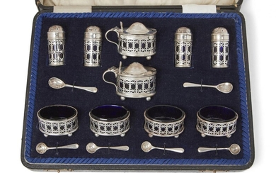 A George V silver and blue glass condiment set, London,...