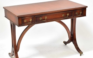 A Georgian-style mahogany side table with three drawers above reeded...