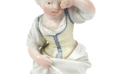 A German porcelain figure of Die verschuttete Milch (The Spilled Milk), probably Hochst, probably c.1775, blue wheel mark, impressed monogram, modelled standing, crying and rubbing her eye, a pot of spilt milk at her feet, on a grassy rocky mound...