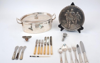 A German silver plated casserole pot, Frankfurt, 1919, B. Bohrmann, of oval form with twin handles and lid, 35cm long, together with a quantity of silver plated flatware and a metal plaque depicting race runners (a lot)